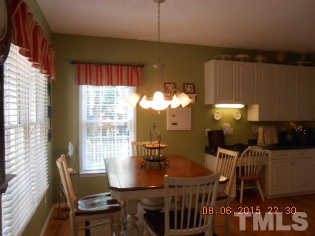 5404 Calverton Drive Raleigh, NC 27613 - Photo 8 of 25 a view of a dining room with furniture window and outside view