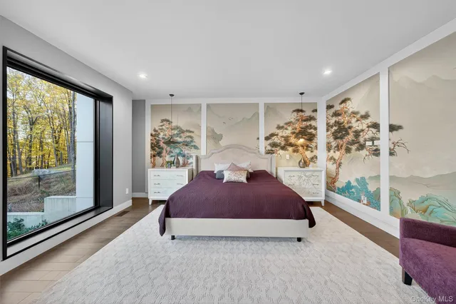 a bedroom with a bed and a large window