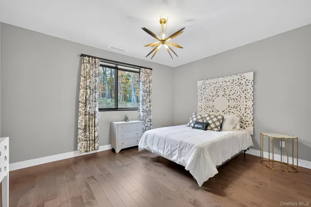 a bedroom with a bed and a dresser in it