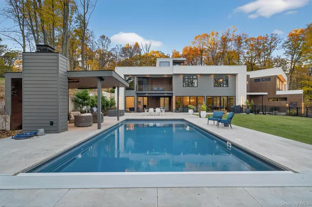 a front view of a house with a yard table and chairs
