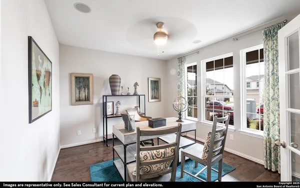 a living room with fireplace furniture and a large window