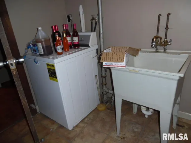 a view of a hallway with wooden floor and front door