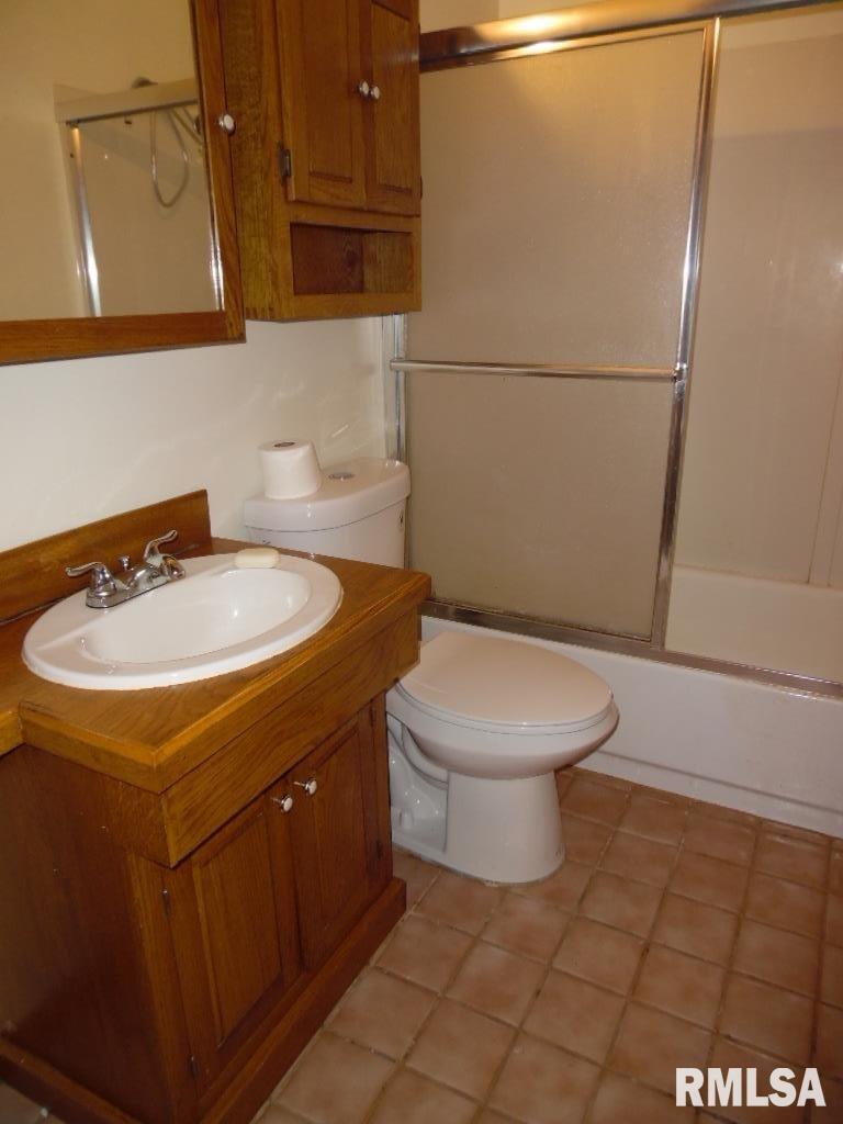1620 North 3rd Street Clinton, IA 52732 - Photo 8 of 20 a bathroom with a sink a toilet and mirror
