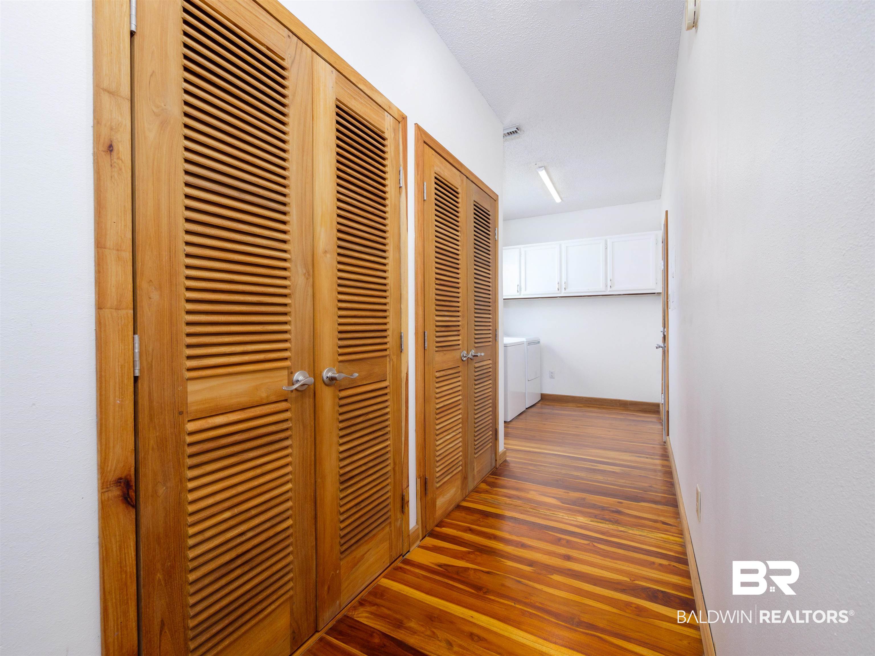 12831 Clay City Road Fairhope, AL 36532 - Photo 22 of 47 2 huge walk in closets with teak doors