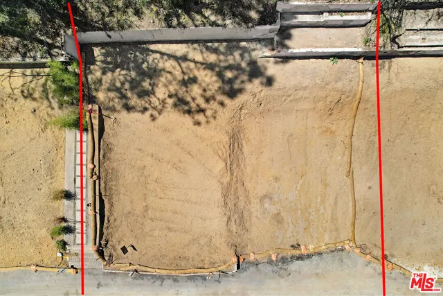 a view of dirt field with trees