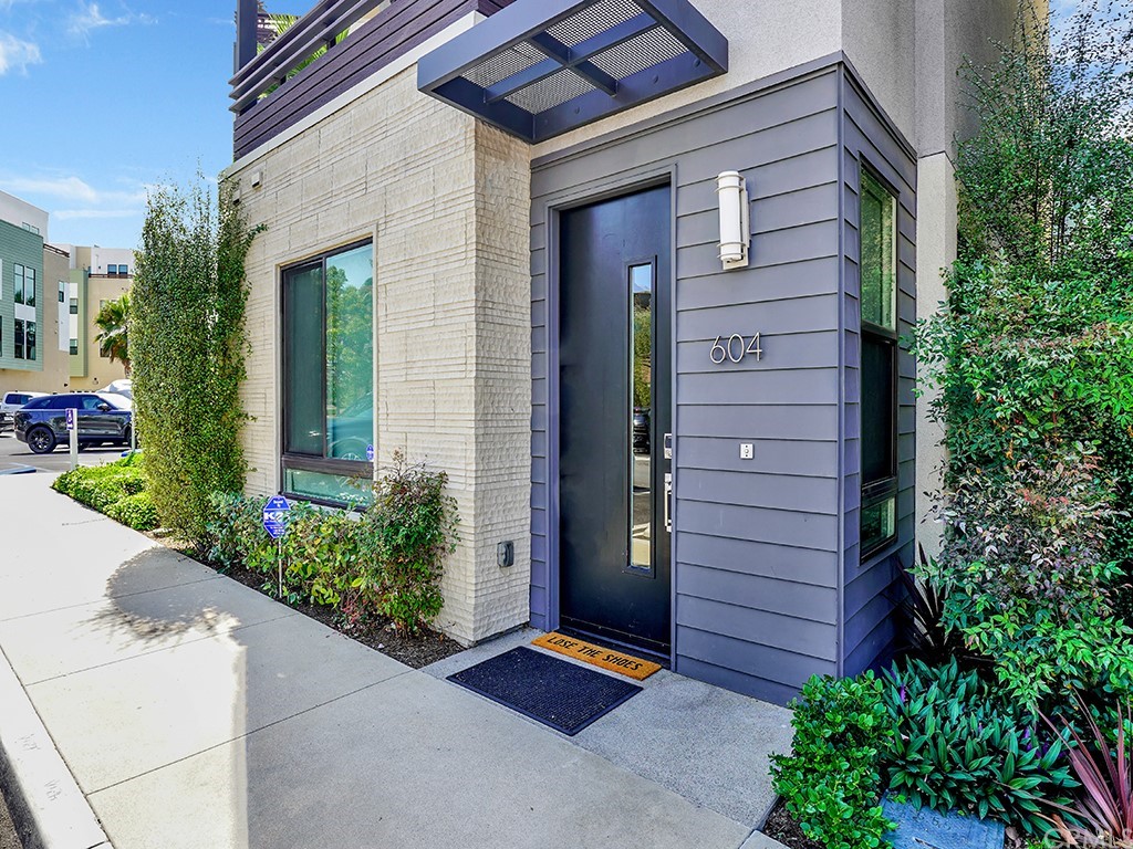 a couple of potted plants in front of door