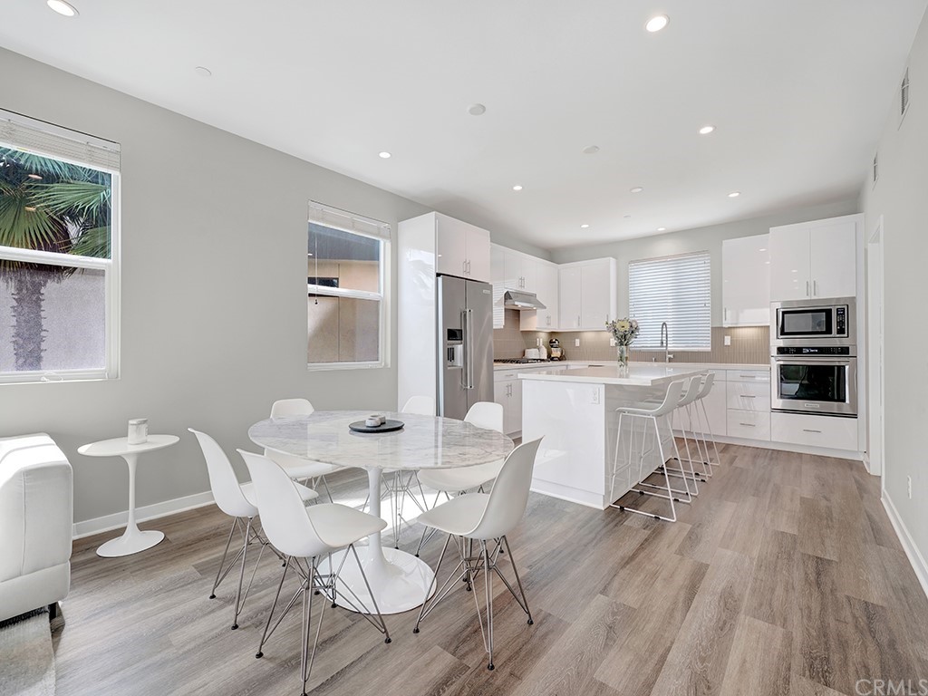 604 Malibu Costa Mesa, CA 92627 - Photo 12 of 40 a dining room with furniture and wooden floor