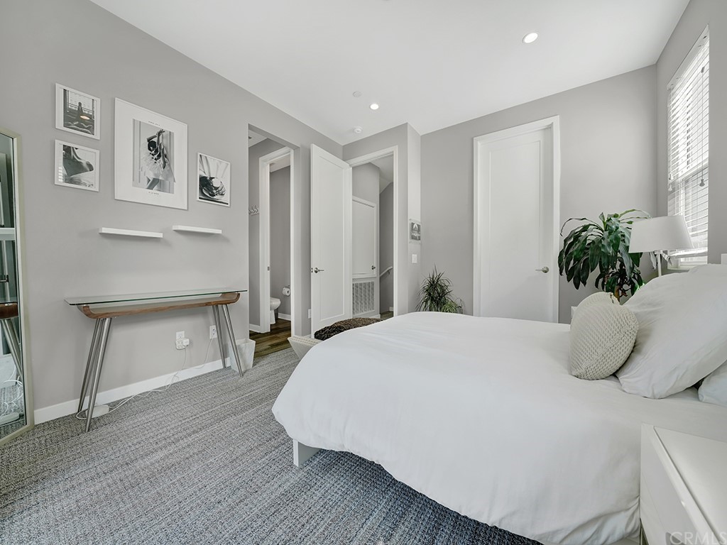 604 Malibu Costa Mesa, CA 92627 - Photo 20 of 40 a bedroom with a bed and a potted plant