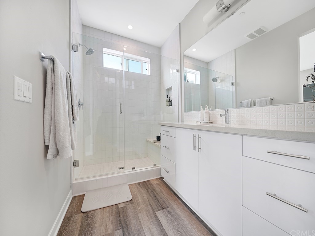 604 Malibu Costa Mesa, CA 92627 - Photo 22 of 40 a bathroom with a tub sink vanity granite and a mirror
