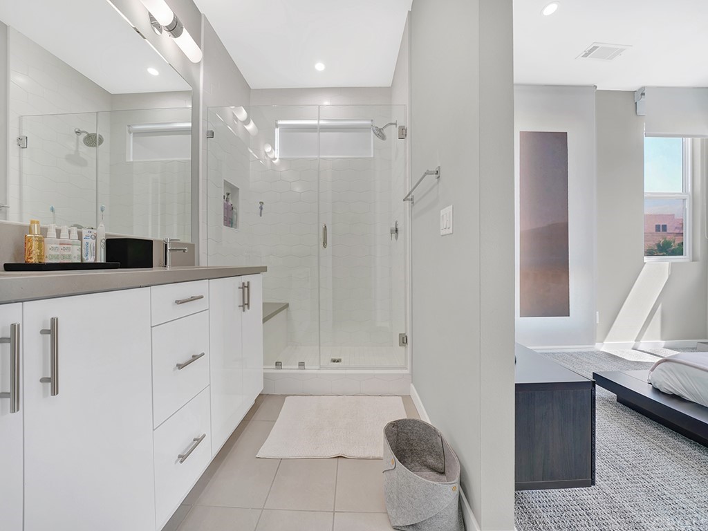 604 Malibu Costa Mesa, CA 92627 - Photo 26 of 40 a bathroom with a tub shower and sink