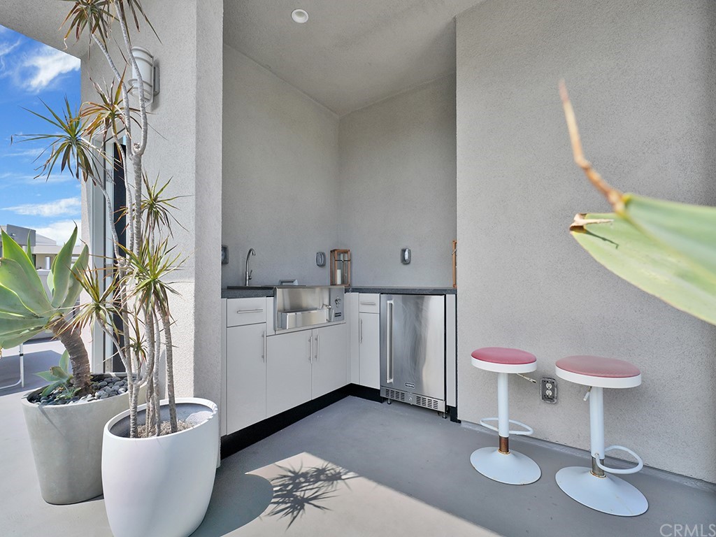 604 Malibu Costa Mesa, CA 92627 - Photo 30 of 40 a living room with furniture and a potted plant