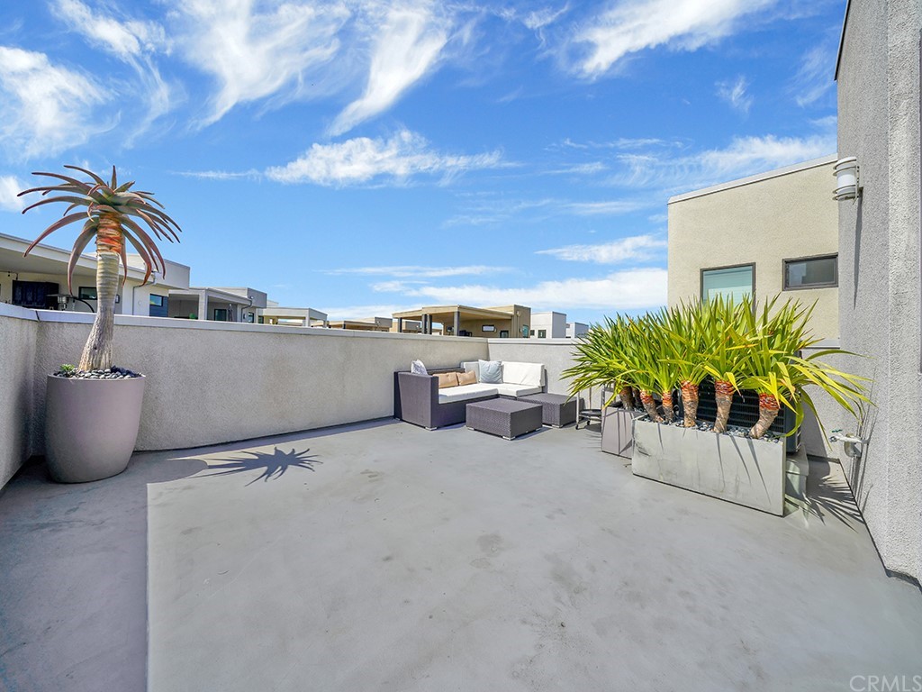 604 Malibu Costa Mesa, CA 92627 - Photo 34 of 40 a view of a terrace with lawn chairs and potted plants