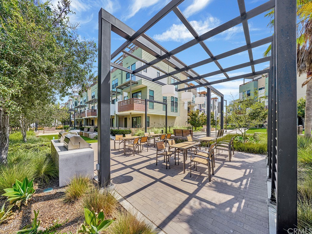 604 Malibu Costa Mesa, CA 92627 - Photo 37 of 40 a view of a patio with chairs and floor to ceiling window