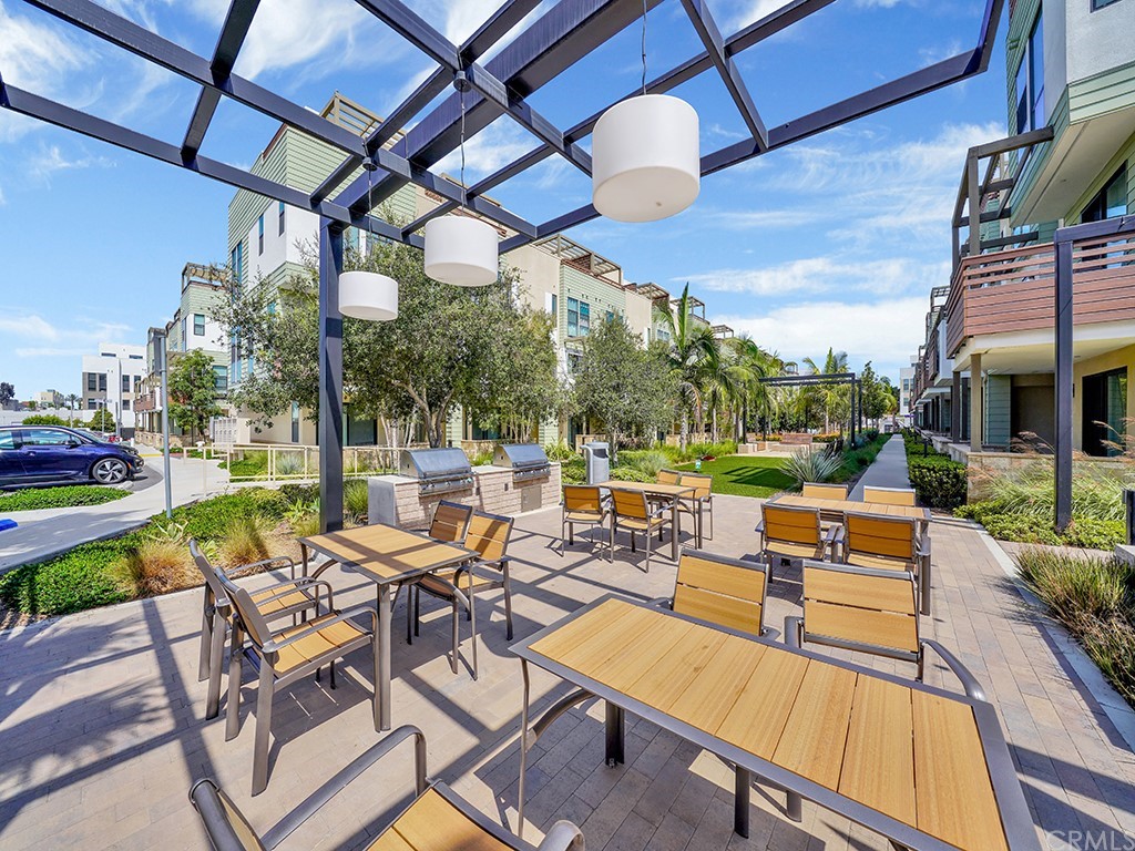 604 Malibu Costa Mesa, CA 92627 - Photo 38 of 40 a view of a patio with couches table and chairs with wooden floor