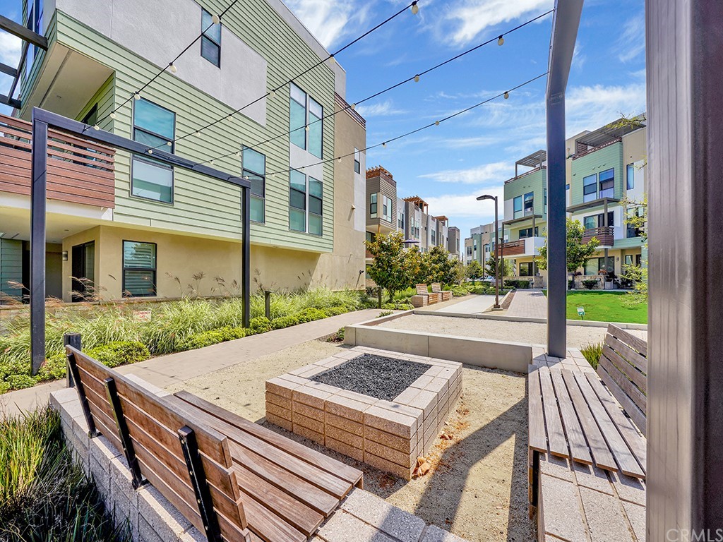 604 Malibu Costa Mesa, CA 92627 - Photo 39 of 40 a view of a patio with table and chairs with wooden floor and fence
