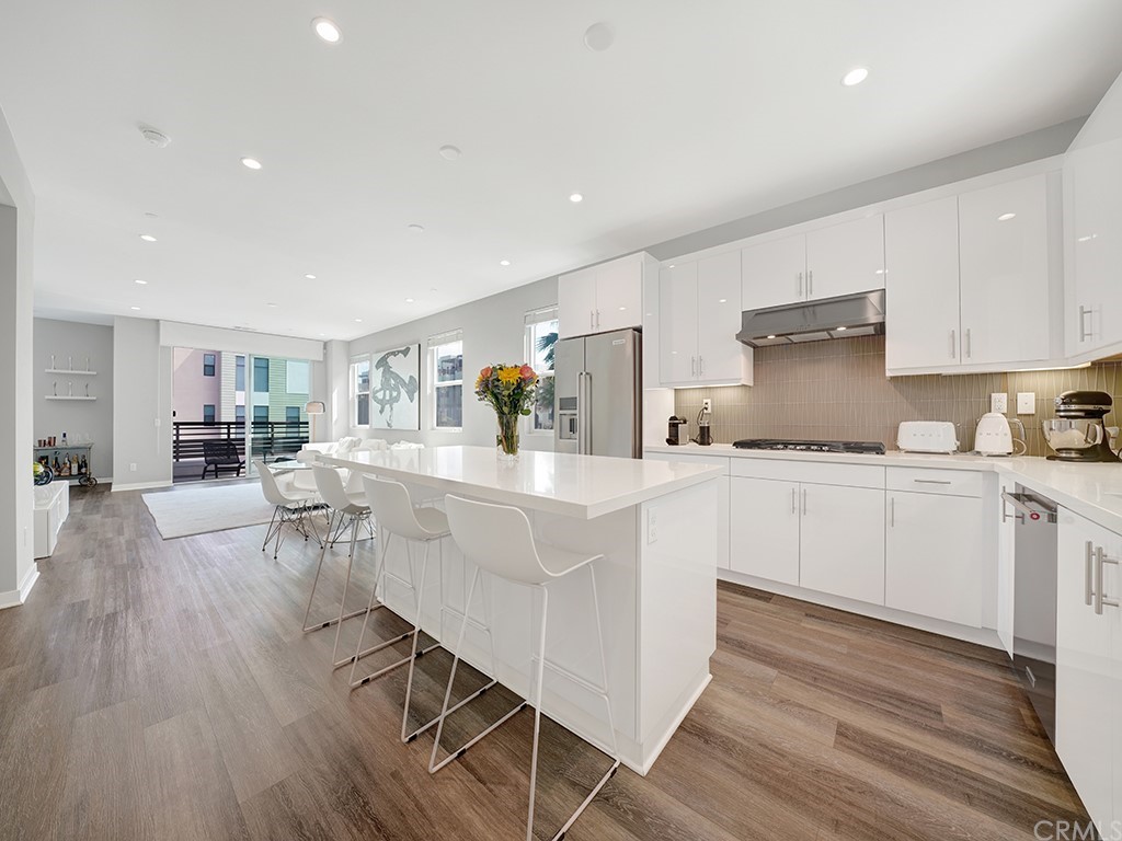 604 Malibu Costa Mesa, CA 92627 - Photo 10 of 40 a kitchen with white cabinets and sink