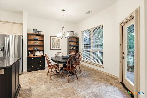 a kitchen with stainless steel appliances granite countertop a stove and a refrigerator