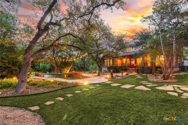 a view of a backyard with large trees