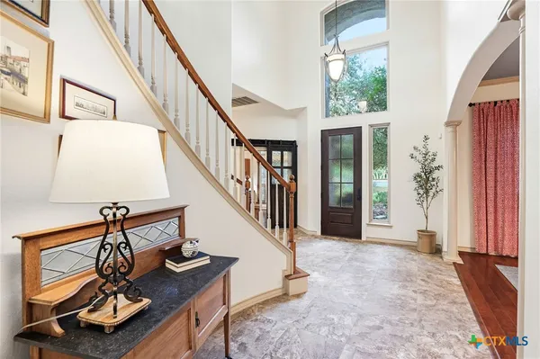 a view of a hallway view with wooden floor and staircase
