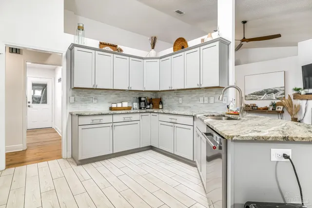 a kitchen with stainless steel appliances granite countertop a sink stove and cabinets