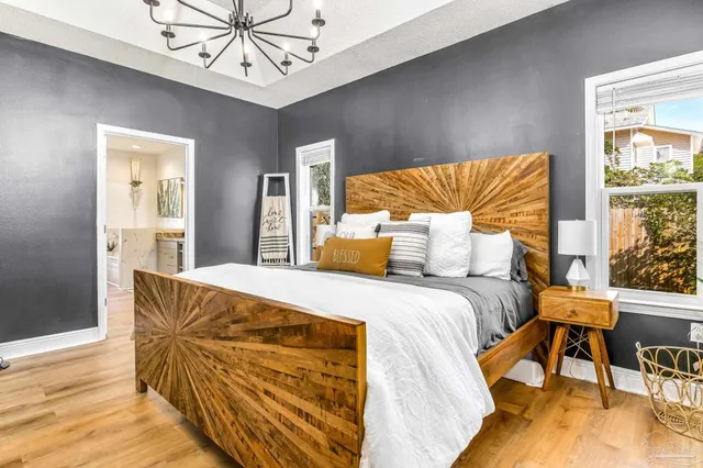 a bedroom with a bed and a chandelier