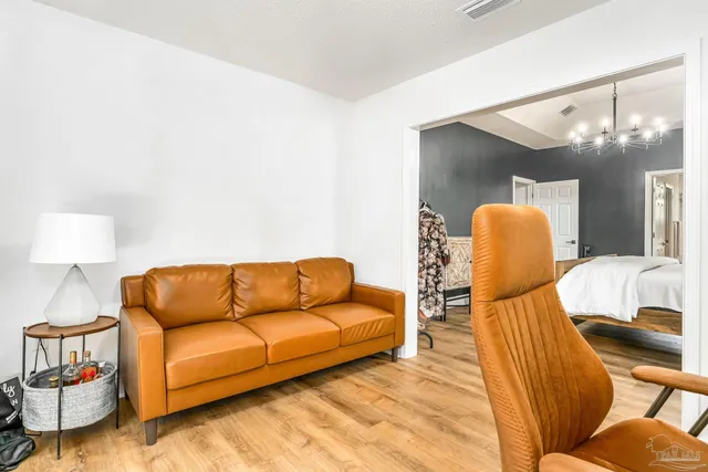 a living room with furniture and a lamp