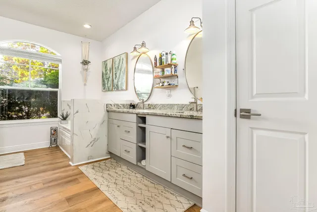 a en suite bathroom with a double vanity sink and a mirror