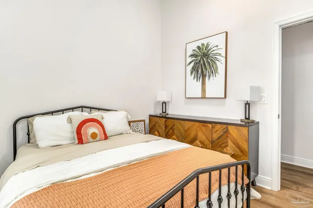 a bedroom with a bed and a painting on the wall