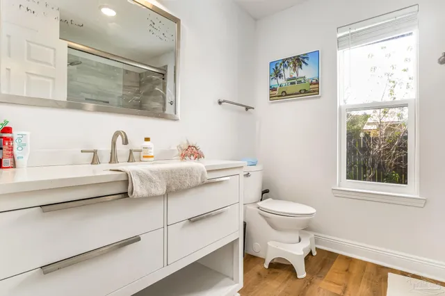 a bathroom with a sink toilet and a mirror