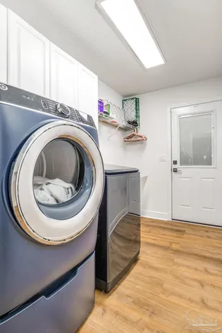 a utility room with sink dryer and washer