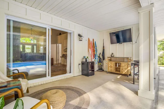 a bedroom with a bed and a view of living room