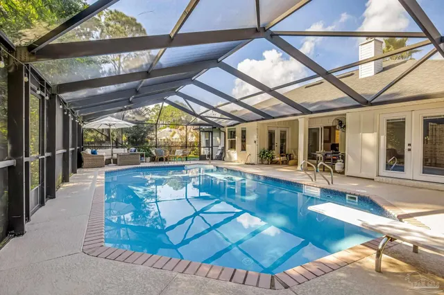 a view of a patio with table and chairs and wooden floor
