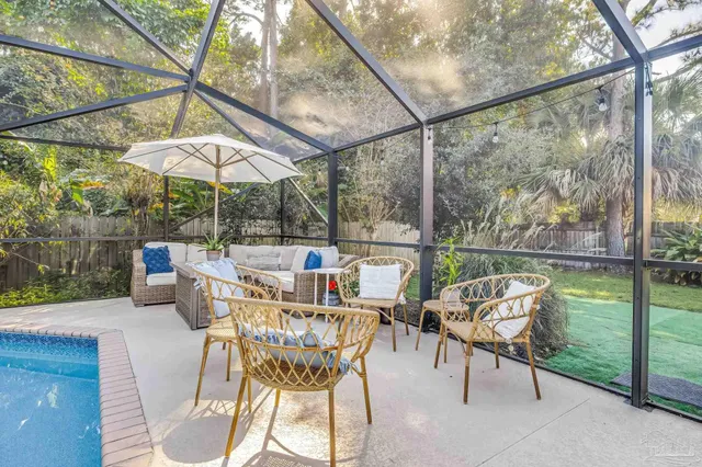 a outdoor space with patio the couches and dining table with a garden view