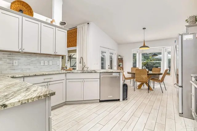 a kitchen with a sink cabinets and window