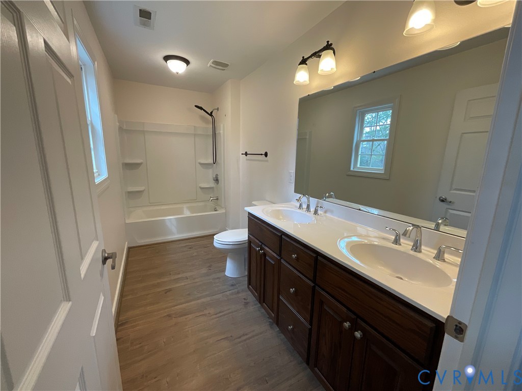 400 Elsassar Road King William, VA 23086 - Photo 13 of 31 a bathroom with a double vanity sink a toilet and shower