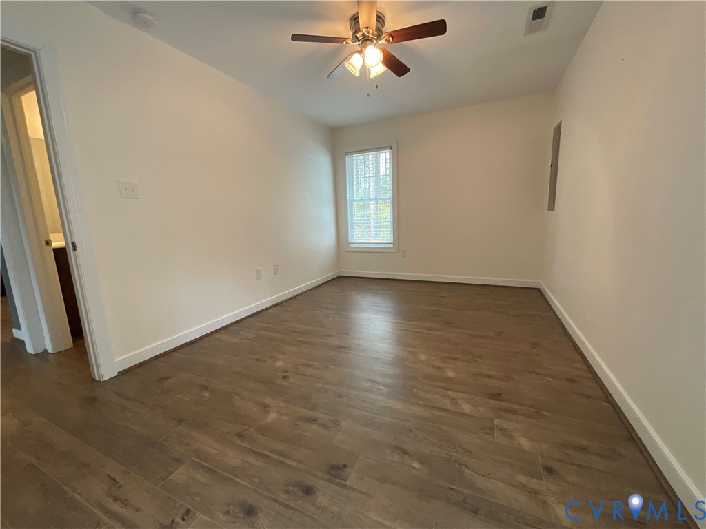 400 Elsassar Road King William, VA 23086 - Photo 16 of 31 an empty room with wooden floor fan and windows