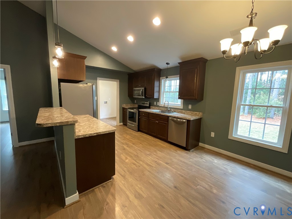 400 Elsassar Road King William, VA 23086 - Photo 9 of 31 a kitchen with stainless steel appliances granite countertop a sink a stove and a refrigerator