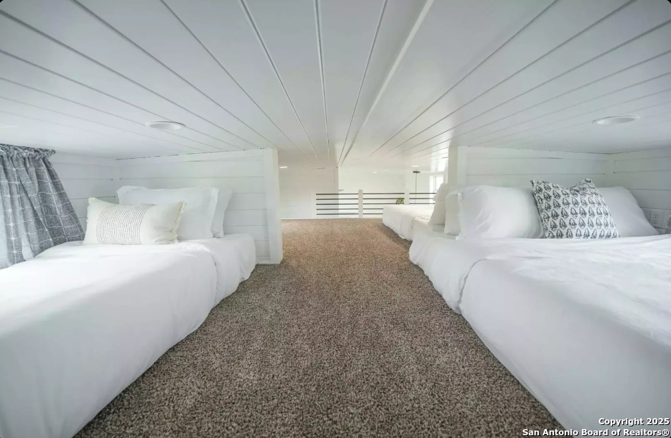 5386 Ranch Road 1376, Unit 97 Fredericksburg, TX 78624 - Photo 16 of 27 a spacious bedroom with a bed and a couch