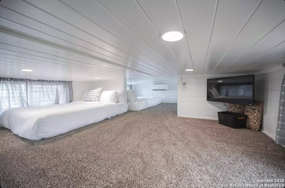 5386 Ranch Road 1376, Unit 97 Fredericksburg, TX 78624 - Photo 17 of 27 a spacious bedroom with a bed and a television