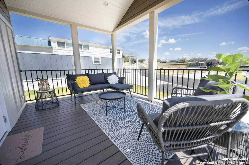 5386 Ranch Road 1376, Unit 97 Fredericksburg, TX 78624 - Photo 19 of 27 a view of a roof deck with dining table and chairs