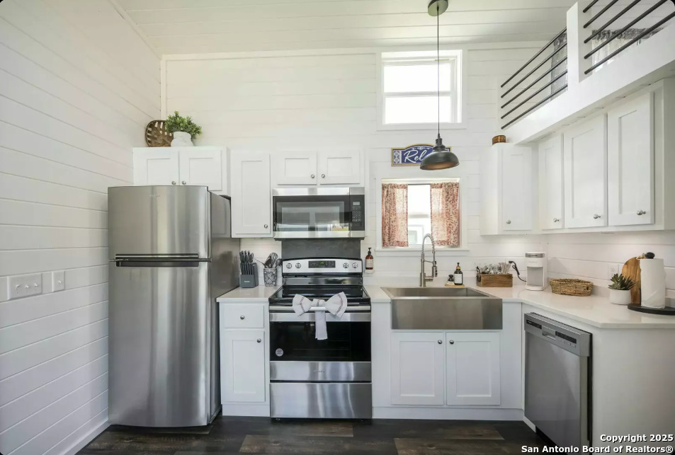 5386 Ranch Road 1376, Unit 97 Fredericksburg, TX 78624 - Photo 6 of 27 a kitchen with refrigerator a stove a sink and a window