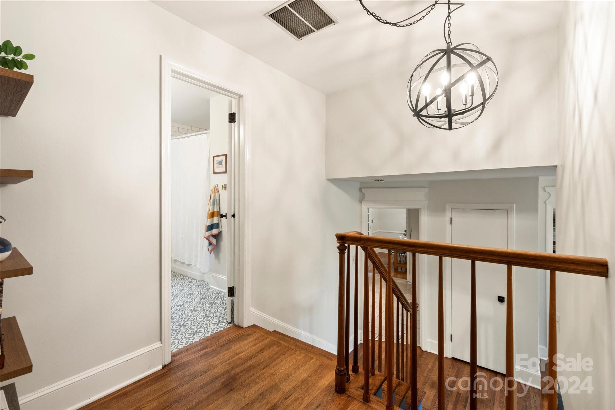 5822 Brookhaven Road Charlotte, NC 28210 - Photo 21 of 48 a view of a hallway with wooden floor and door