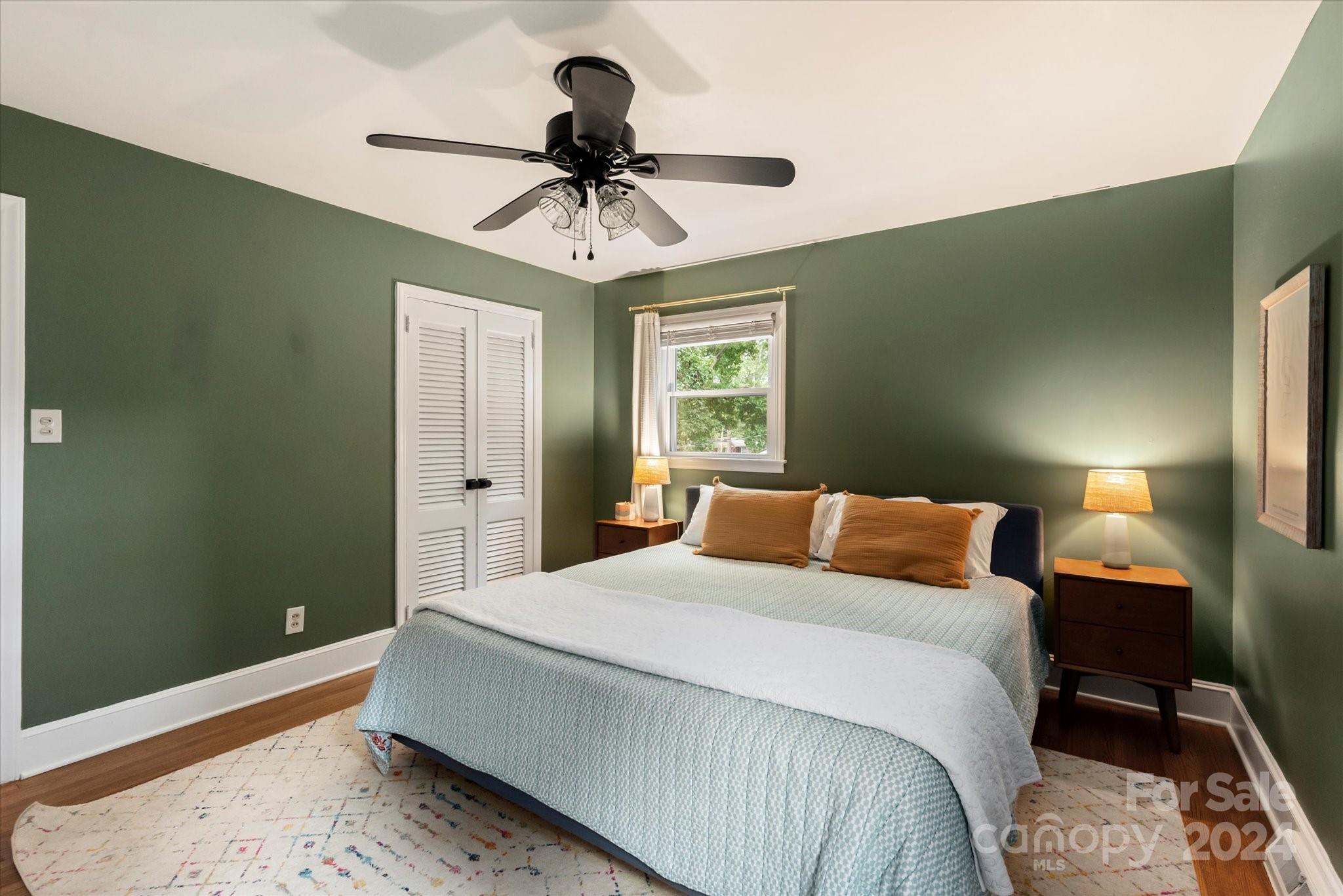 5822 Brookhaven Road Charlotte, NC 28210 - Photo 23 of 48 a bedroom with a bed and a chandelier
