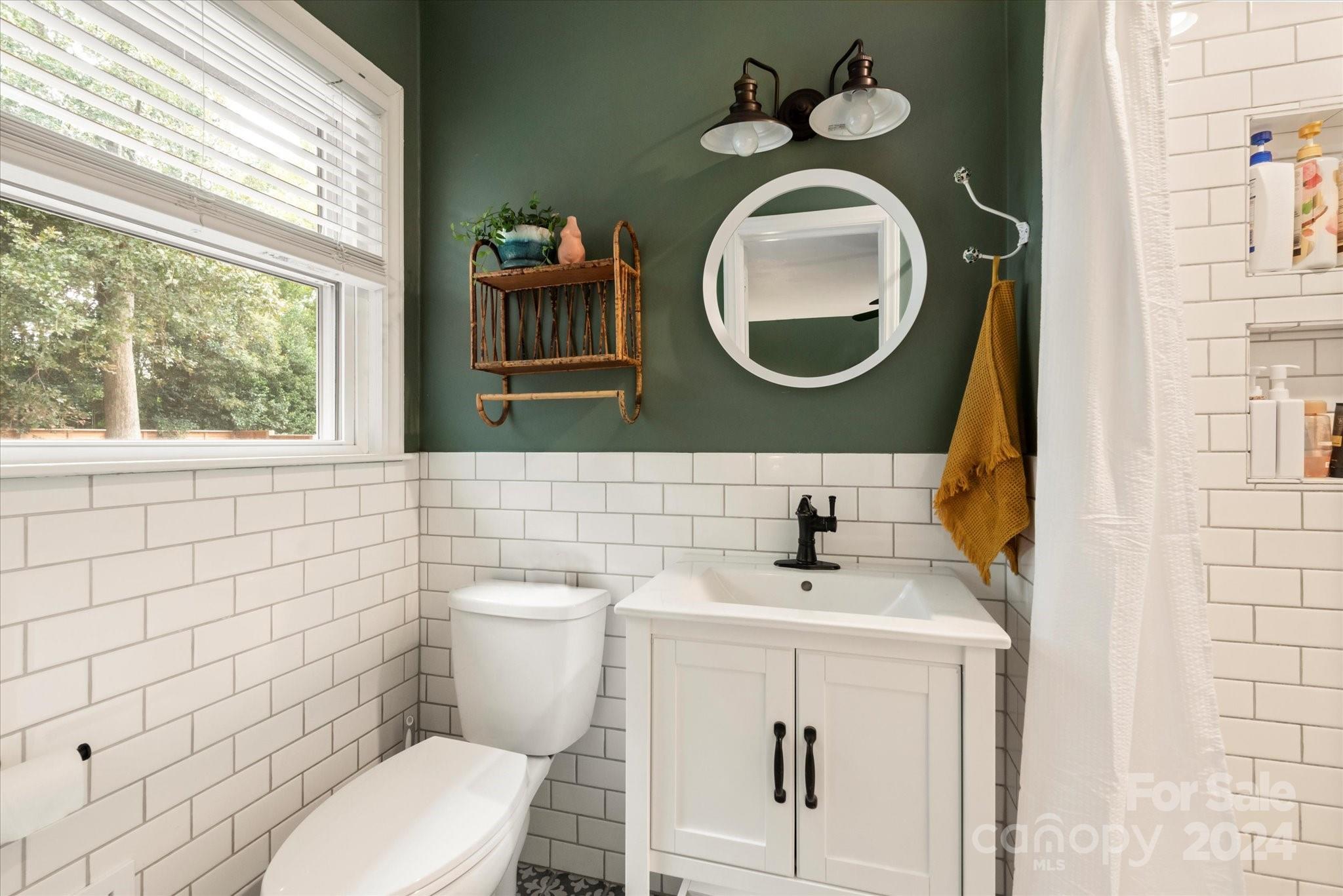 5822 Brookhaven Road Charlotte, NC 28210 - Photo 24 of 48 a bathroom with a toilet a sink and mirror