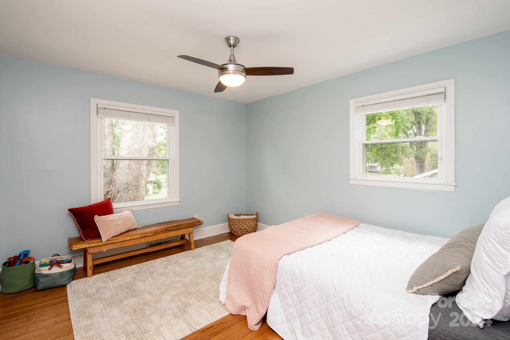 5822 Brookhaven Road Charlotte, NC 28210 - Photo 29 of 48 a bedroom with a bed and wooden floor