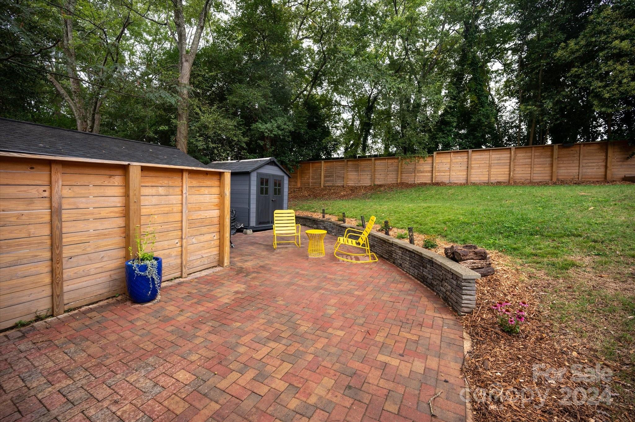 5822 Brookhaven Road Charlotte, NC 28210 - Photo 44 of 48 a view of a backyard with plants and large tree