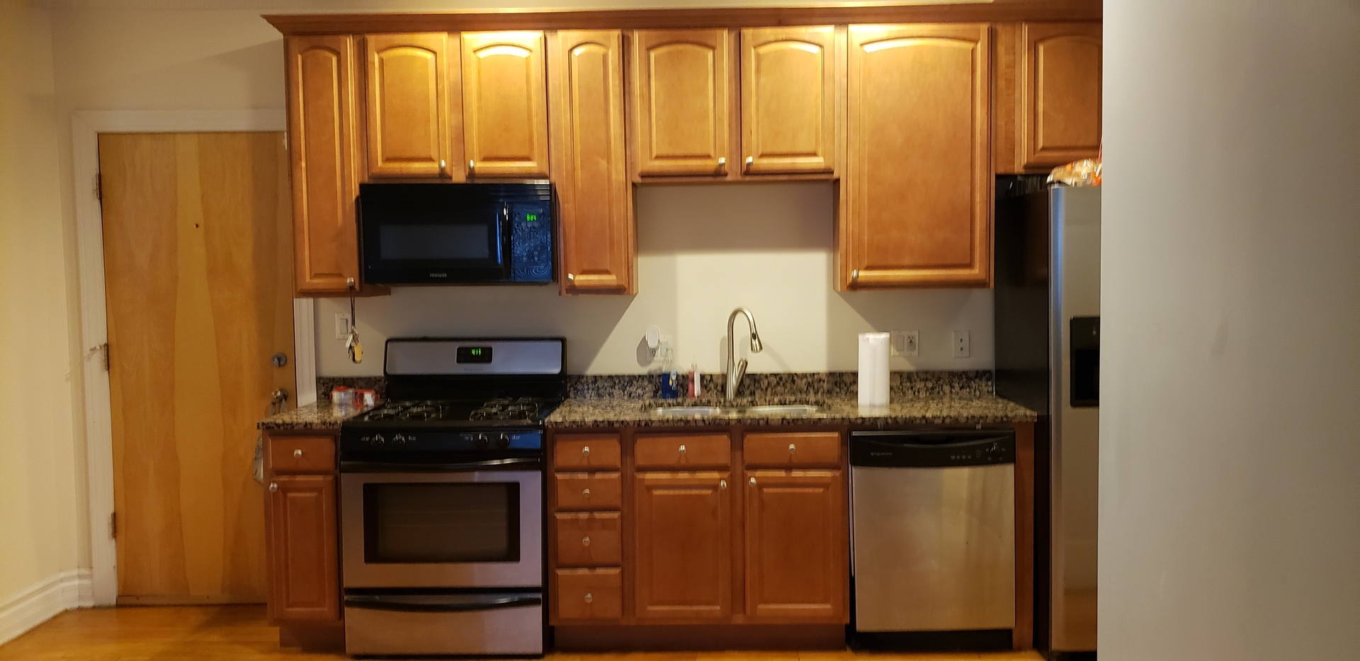 917 East 78th Street, Unit 101W Chicago, IL 60619 - Photo 2 of 8 a kitchen with stainless steel appliances granite countertop a stove and a microwave