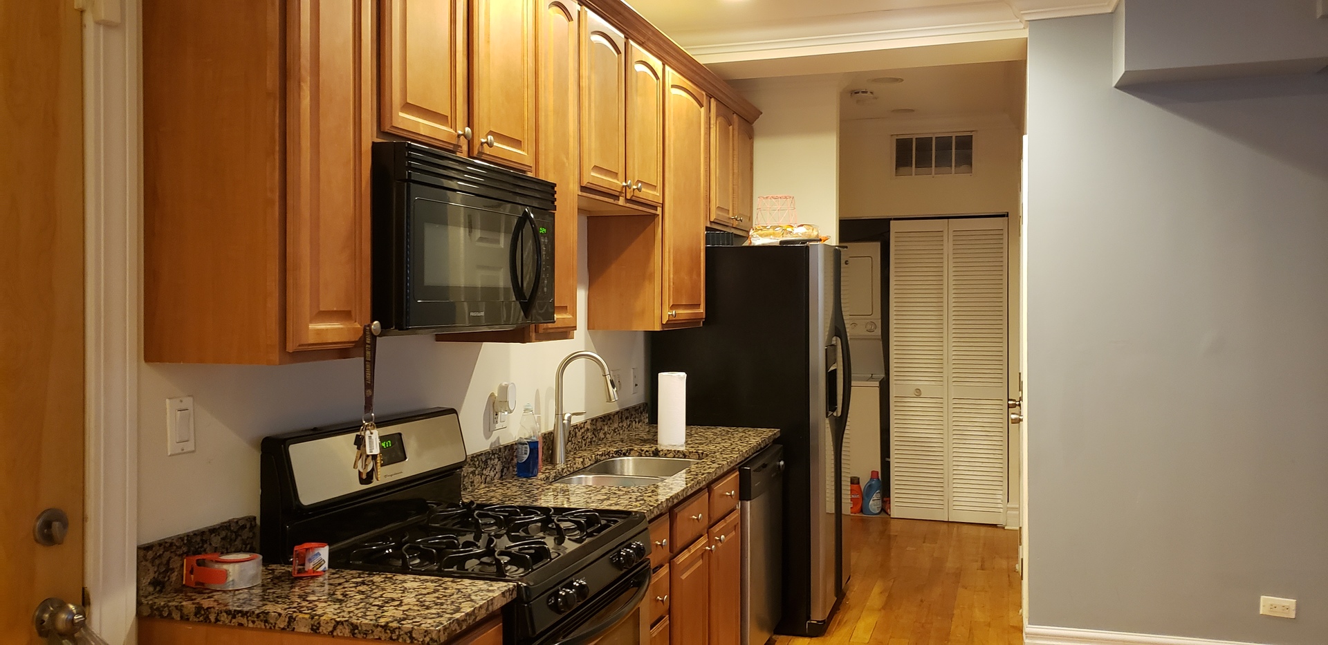 917 East 78th Street, Unit 101W Chicago, IL 60619 - Photo 3 of 8 a kitchen with stainless steel appliances granite countertop a refrigerator and a stove