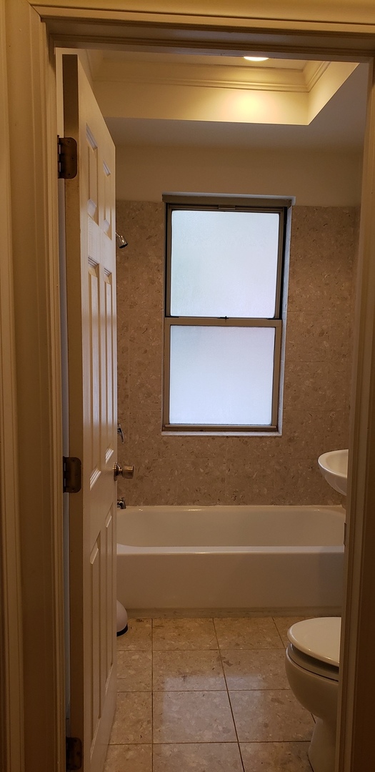 917 East 78th Street, Unit 101W Chicago, IL 60619 - Photo 8 of 8 a bathroom with a toilet and a shower