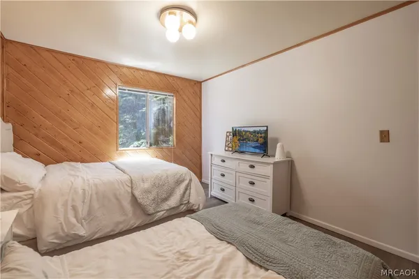 a bedroom with a bed and dresser